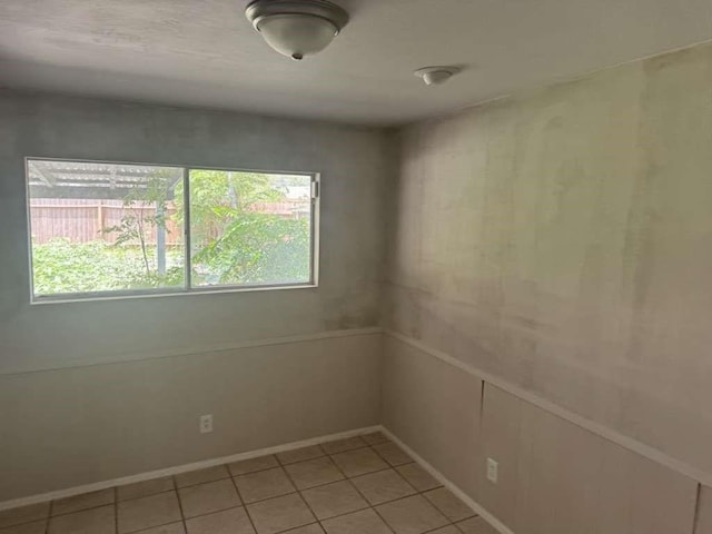426 Pennington Dr, Corpus Christi, TX 78412 - unfurnished room with healthy amount of natural light, light tile patterned floors, and baseboards