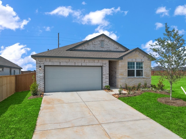 27506 Beachside Arbor Dr, Katy, TX 77493 - view of front of property featuring roof with shingles, driveway, an attached garage, and stone siding