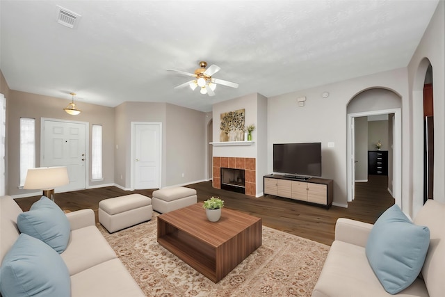 2202 Donrel Way, Houston, TX 77067 - living area with wood finished floors, baseboards, ceiling fan, arched walkways, and a tiled fireplace