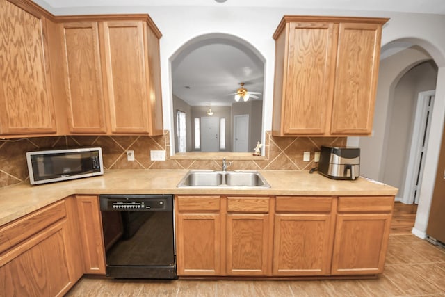 2202 Donrel Way, Houston, TX 77067 - kitchen with black dishwasher, stainless steel microwave, a sink, arched walkways, and a ceiling fan