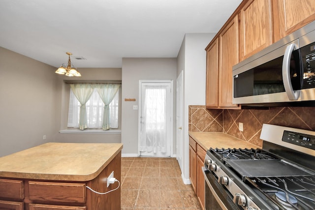 2202 Donrel Way, Houston, TX 77067 - kitchen with stainless steel appliances, decorative backsplash, a chandelier, light countertops, and a center island