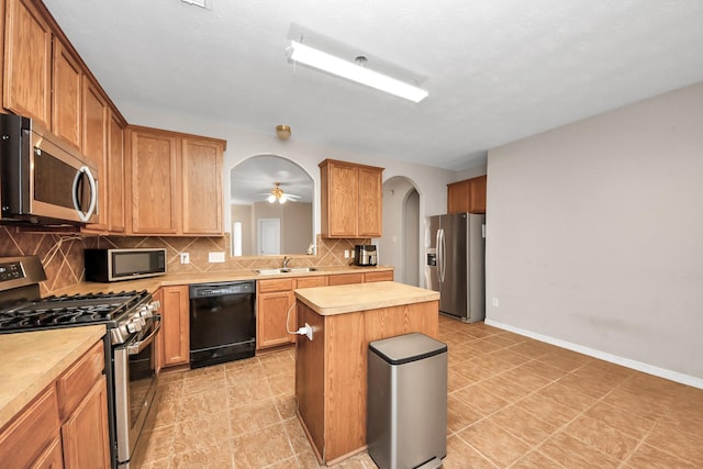 2202 Donrel Way, Houston, TX 77067 - kitchen with stainless steel appliances, a sink, arched walkways, light countertops, and tasteful backsplash