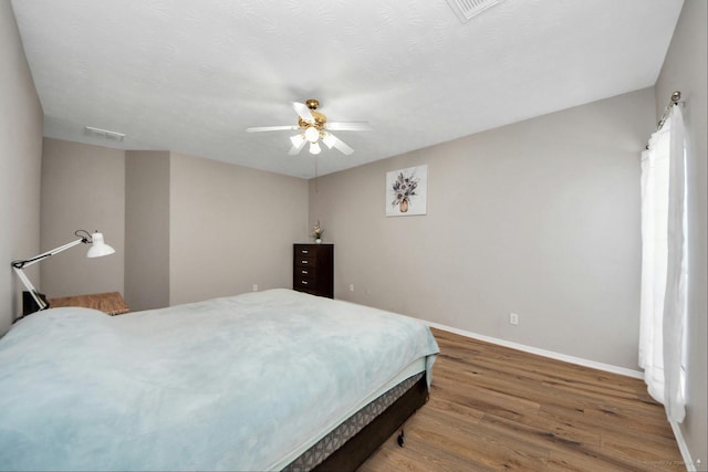 2202 Donrel Way, Houston, TX 77067 - bedroom with baseboards, wood finished floors, and ceiling fan