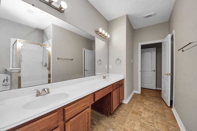 2202 Donrel Way, Houston, TX 77067 - bathroom featuring double vanity, a stall shower, baseboards, and stone finish floors