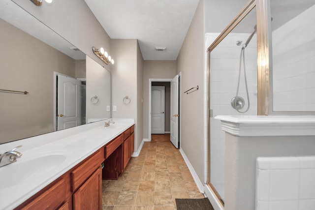 2202 Donrel Way, Houston, TX 77067 - bathroom with a shower stall, double vanity, baseboards, and stone finish flooring