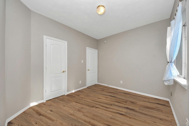 2202 Donrel Way, Houston, TX 77067 - unfurnished bedroom with wood finished floors and baseboards