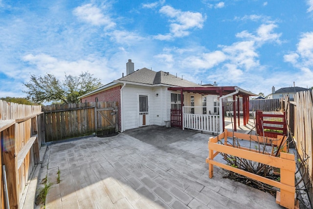 2202 Donrel Way, Houston, TX 77067 - back of property featuring a patio, a fenced backyard, and a chimney