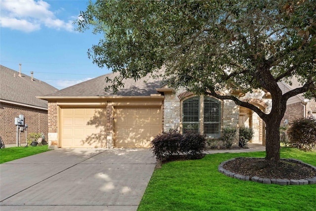 10910 Brighton Gardens Dr, Richmond, TX 77406 - view of front of house with a garage, stone siding, concrete driveway, and a front lawn