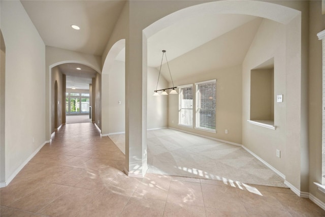 10910 Brighton Gardens Dr, Richmond, TX 77406 - hallway featuring arched walkways, baseboards, vaulted ceiling, and recessed lighting