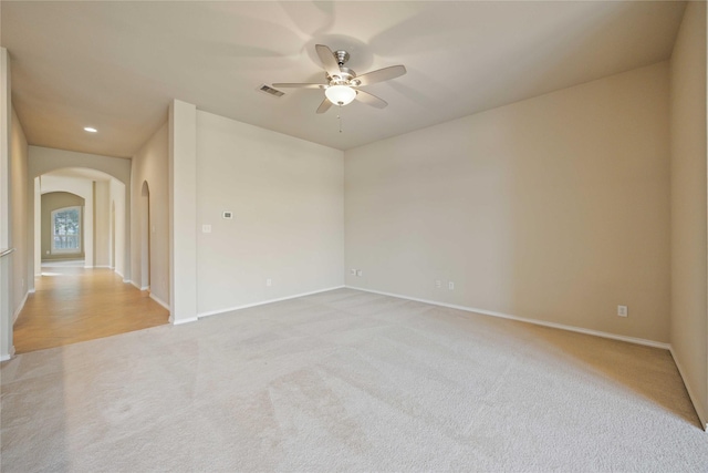 10910 Brighton Gardens Dr, Richmond, TX 77406 - unfurnished room featuring arched walkways, a ceiling fan, light colored carpet, baseboards, and recessed lighting