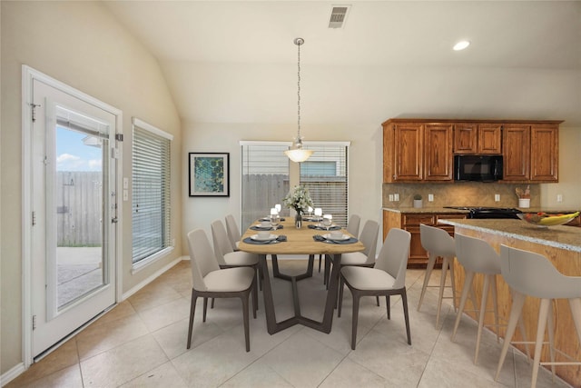 10910 Brighton Gardens Dr, Richmond, TX 77406 - dining space with healthy amount of natural light, lofted ceiling, light tile patterned floors, baseboards, and recessed lighting