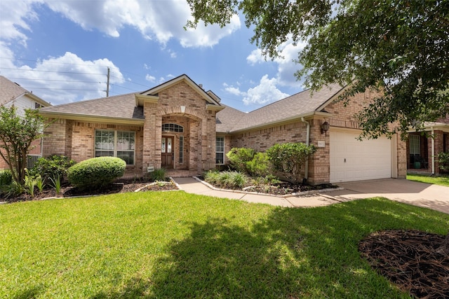 19107 W Sawtooth Canyon Dr, Tomball, TX 77377 - view of front of house with brick siding, roof with shingles, a front lawn, concrete driveway, and a garage