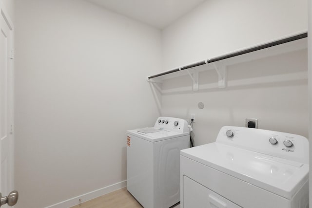 21406 George Wayne Way, Spring, TX 77379 - washroom with washing machine and clothes dryer, baseboards, and light wood-style floors