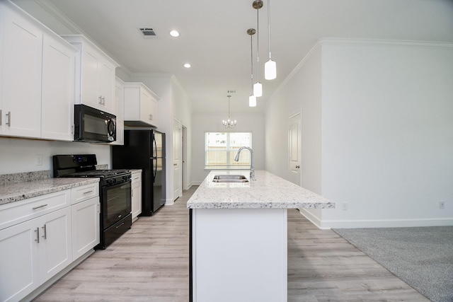 6607 Apollo, Houston, TX 77091 - kitchen featuring black appliances, a sink, crown molding, a chandelier, and a kitchen island with sink