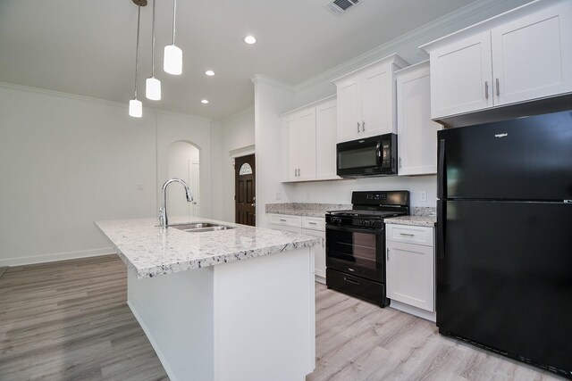 6607 Apollo, Houston, TX 77091 - kitchen with black appliances, a sink, crown molding, a center island with sink, and light wood finished floors