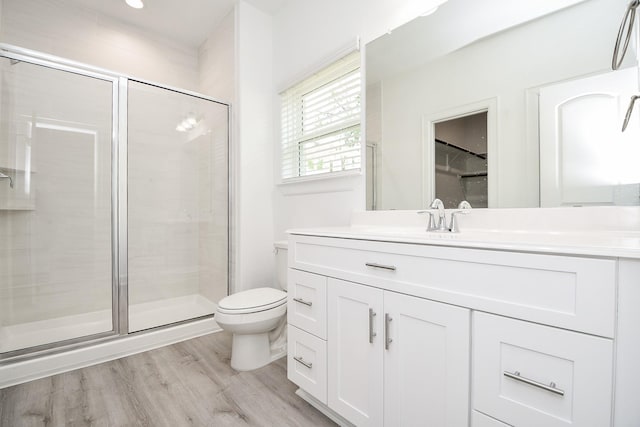 6607 Apollo, Houston, TX 77091 - bathroom featuring vanity, toilet, a stall shower, and wood finished floors