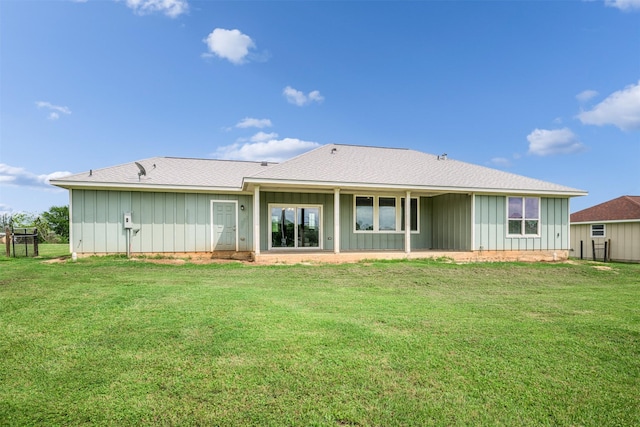 305-335 Omalley Rd, Brenham, TX 77833 - rear view of property with board and batten siding, a yard, roof with shingles, and a patio area