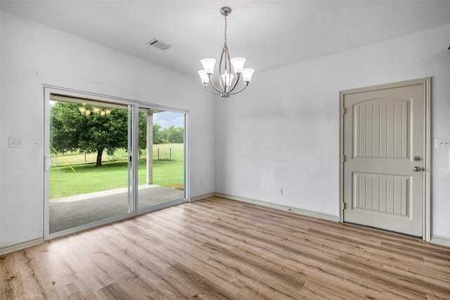 305-335 Omalley Rd, Brenham, TX 77833 - unfurnished room featuring wood finished floors, a chandelier, and baseboards