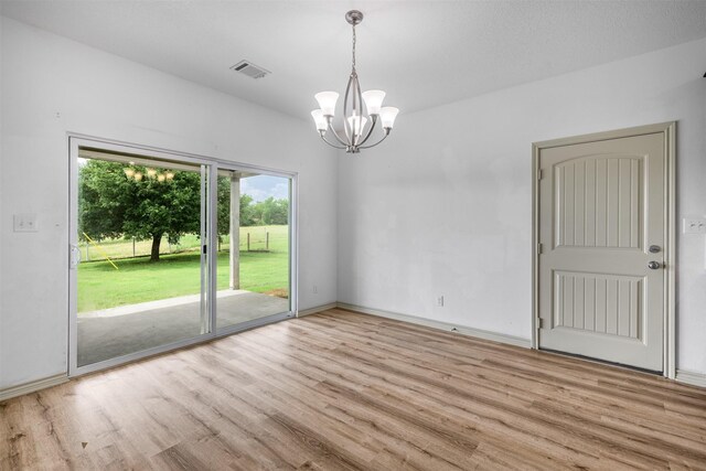 305-335 Omalley Rd, Brenham, TX 77833 - empty room with wood finished floors, a chandelier, and baseboards