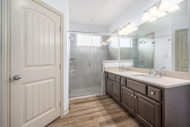 305-335 Omalley Rd, Brenham, TX 77833 - bathroom featuring double vanity, a stall shower, and wood finished floors