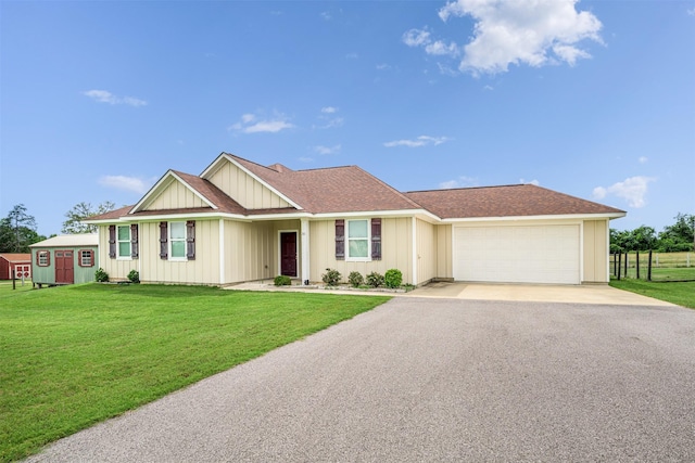 305-335 Omalley Rd, Brenham, TX 77833 - single story home with driveway, a garage, board and batten siding, and a front lawn