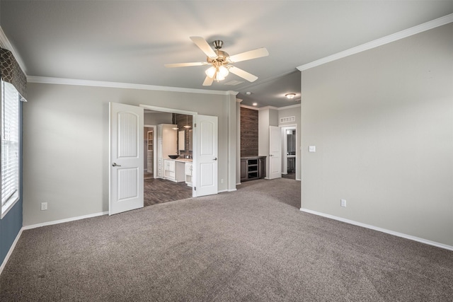305-335 Omalley Rd, Brenham, TX 77833 - unfurnished bedroom with dark colored carpet, baseboards, ornamental molding, and ensuite bathroom