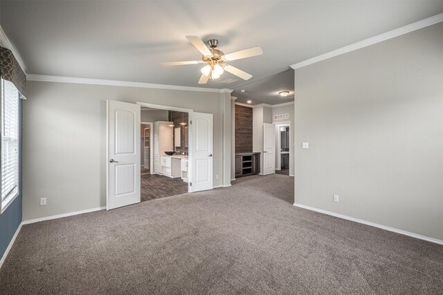 305-335 Omalley Rd, Brenham, TX 77833 - unfurnished bedroom with dark carpet, baseboards, ornamental molding, and ensuite bath