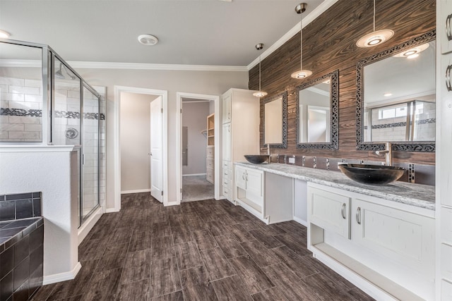 305-335 Omalley Rd, Brenham, TX 77833 - full bath with a stall shower, ornamental molding, double vanity, wood finished floors, and baseboards