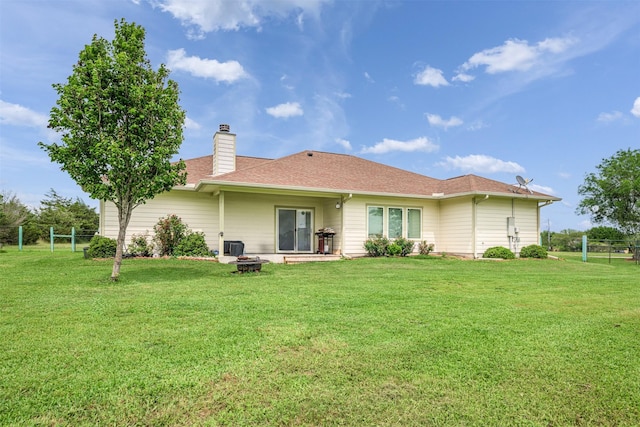 305-335 Omalley Rd, Brenham, TX 77833 - rear view of house featuring an outdoor fire pit, a yard, a chimney, and roof with shingles