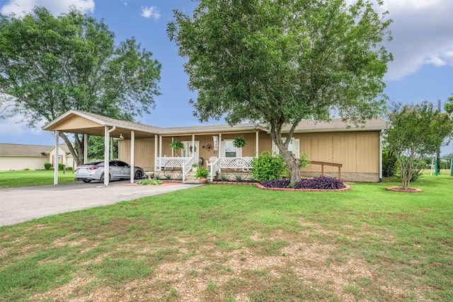 305-335 Omalley Rd, Brenham, TX 77833 - view of front facade with a porch, an attached carport, a front lawn, and asphalt driveway