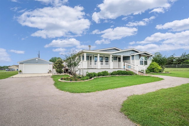 305-335 Omalley Rd, Brenham, TX 77833 - view of front of house featuring a porch, board and batten siding, an outbuilding, and asphalt driveway