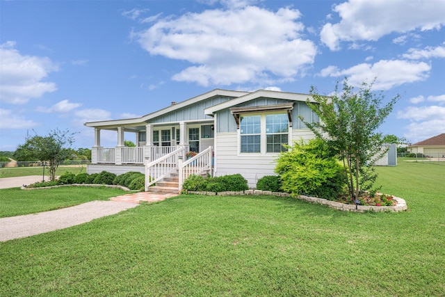 305-335 Omalley Rd, Brenham, TX 77833 - view of front facade with board and batten siding, covered porch, and a front yard