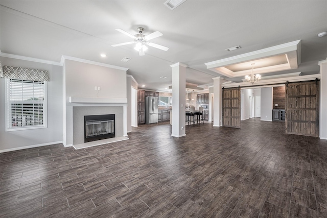 305-335 Omalley Rd, Brenham, TX 77833 - unfurnished living room with a barn door, crown molding, a glass covered fireplace, baseboards, and a ceiling fan