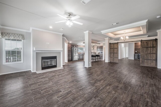305-335 Omalley Rd, Brenham, TX 77833 - unfurnished living room with a barn door, ornamental molding, a glass covered fireplace, baseboards, and ceiling fan