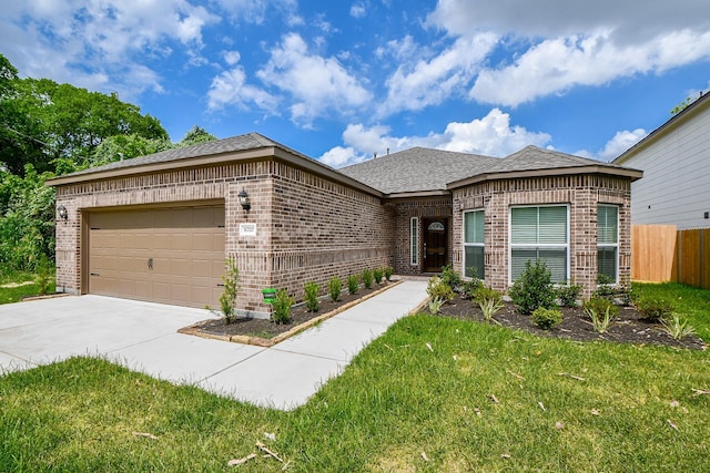 6710 Utah St, Houston, TX 77091 - view of front of home featuring brick siding, an attached garage, driveway, and roof with shingles