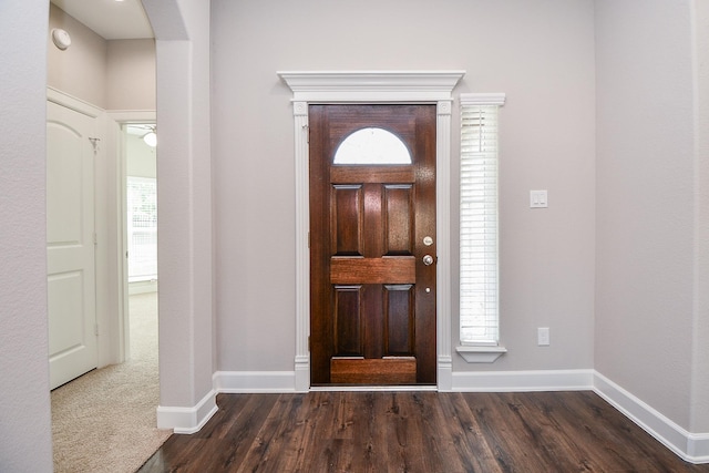 6710 Utah St, Houston, TX 77091 - foyer featuring baseboards, dark wood-type flooring, and arched walkways