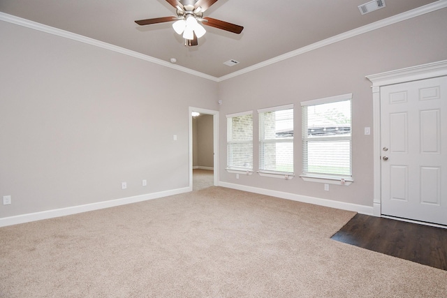 6710 Utah St, Houston, TX 77091 - carpeted foyer entrance featuring ornamental molding, ceiling fan, and baseboards