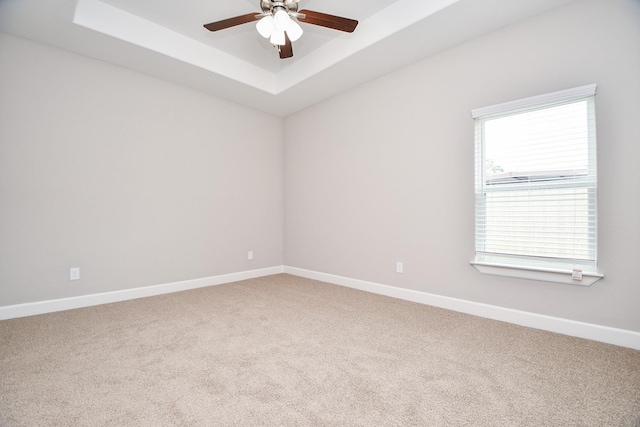 6710 Utah St, Houston, TX 77091 - unfurnished room with light colored carpet, a tray ceiling, a ceiling fan, and baseboards