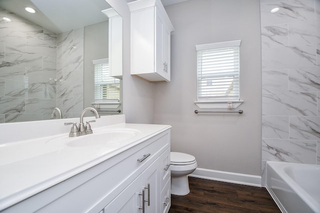6710 Utah St, Houston, TX 77091 - full bathroom with vanity, toilet, baseboards, wood finished floors, and shower / bathtub combination