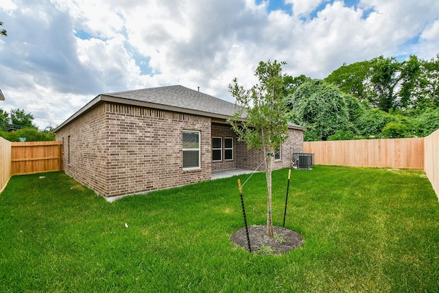 6710 Utah St, Houston, TX 77091 - rear view of property featuring central AC, brick siding, and a shingled roof