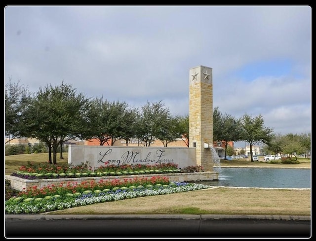 5442 Atwood Canyon Ct, Richmond, TX 77407 - community sign with a water view and a lawn
