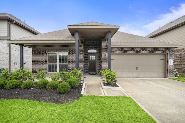 5442 Atwood Canyon Ct, Richmond, TX 77407 - view of front of property with brick siding, an attached garage, driveway, and a shingled roof