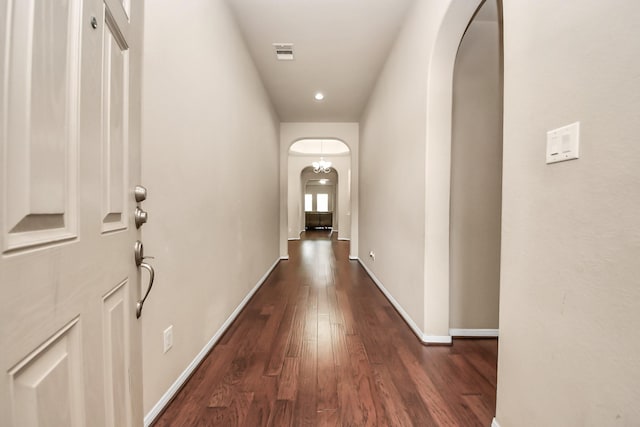 13906 Mowbray Ct, Richmond, TX 77407 - hallway featuring arched walkways, dark wood-type flooring, and baseboards
