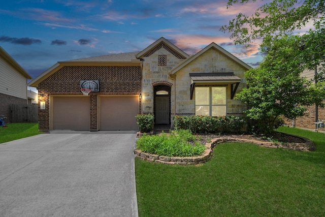 13906 Mowbray Ct, Richmond, TX 77407 - view of front of home featuring driveway, stone siding, a yard, an attached garage, and brick siding