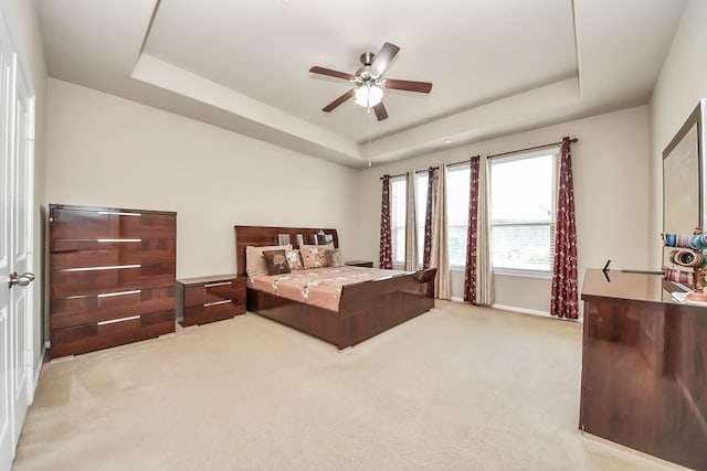 13906 Mowbray Ct, Richmond, TX 77407 - bedroom with a tray ceiling, light carpet, and a ceiling fan