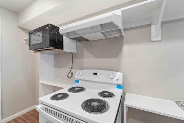 1405 Shadowdale Dr Unit 73, Houston, TX 77043 - kitchen with white electric range, extractor fan, black microwave, wood finished floors, and baseboards