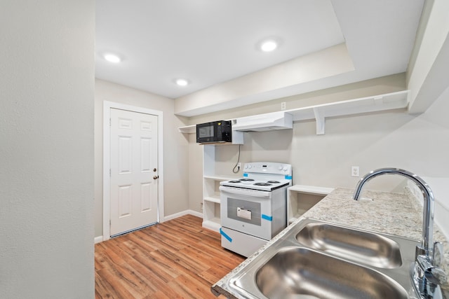 1405 Shadowdale Dr Unit 73, Houston, TX 77043 - kitchen with white electric range, under cabinet range hood, a sink, open shelves, and light wood-style flooring