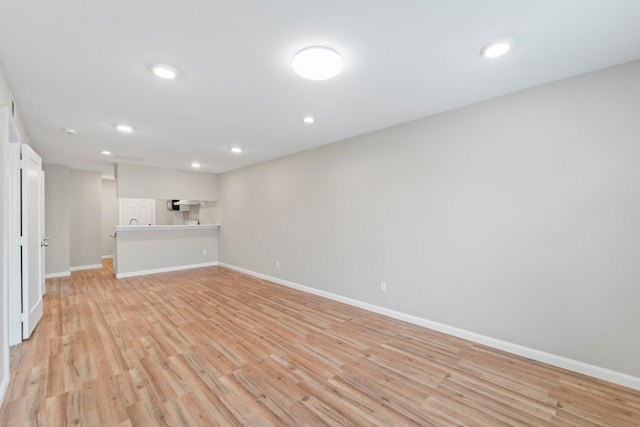1405 Shadowdale Dr Unit 73, Houston, TX 77043 - unfurnished living room with light wood-type flooring, baseboards, and recessed lighting