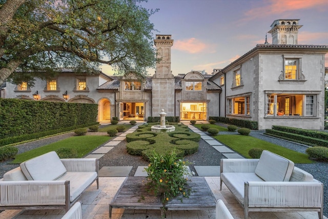 2307 River Oaks Blvd, Houston, TX 77019 - back of property with an outdoor hangout area, stucco siding, and a patio area