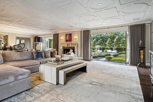 2307 River Oaks Blvd, Houston, TX 77019 - living area with an ornate ceiling, plenty of natural light, a warm lit fireplace, wood finished floors, and crown molding